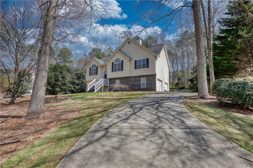 1006 English Oak Lane Winder, GA 30680 - Photo 60 of 83 a front view of a house with a yard and garage