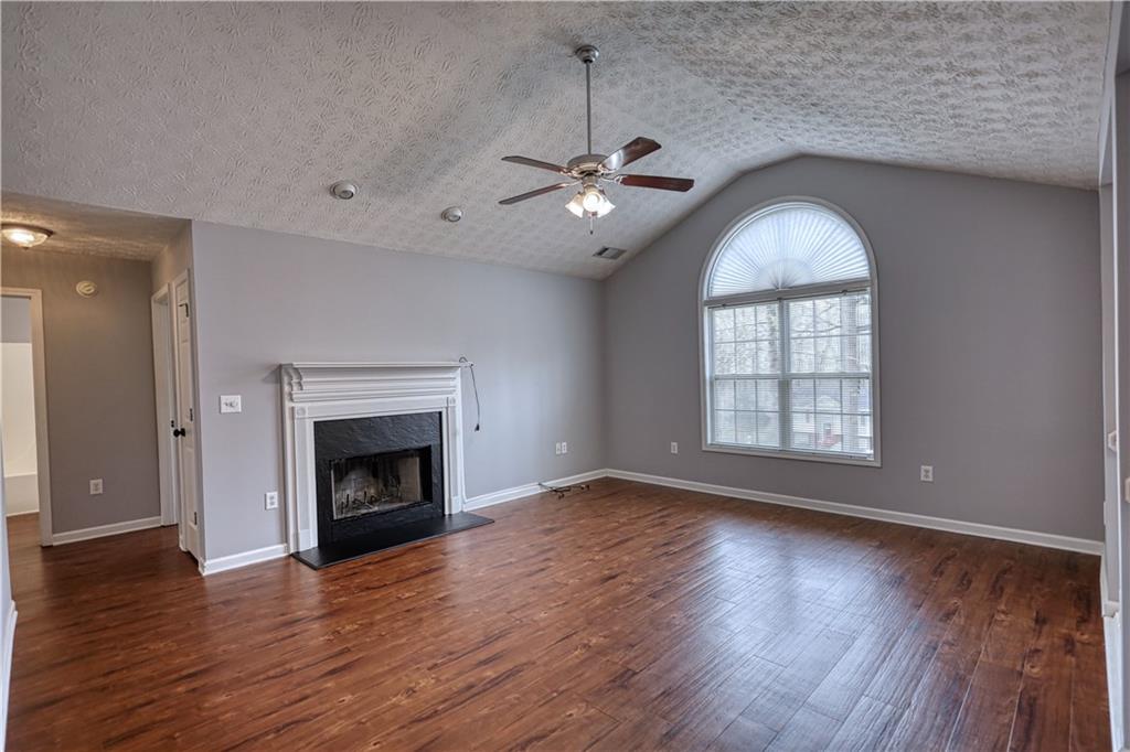 1006 English Oak Lane Winder, GA 30680 - Photo 6 of 83 an empty room with wooden floor fireplace and windows