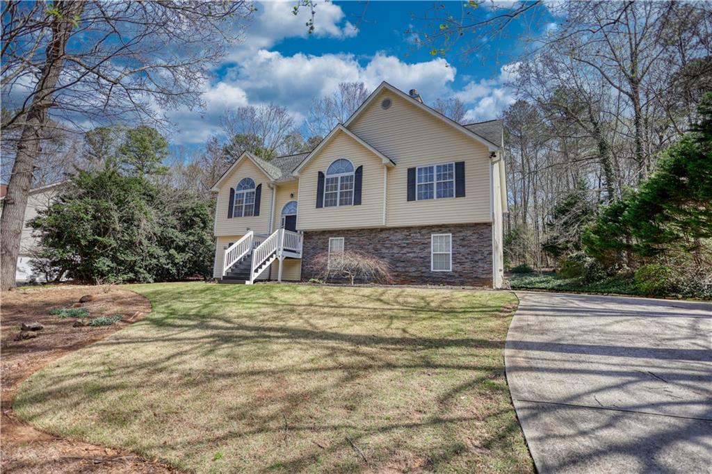 1006 English Oak Lane Winder, GA 30680 - Photo 61 of 83 a front view of a house with a yard and garage