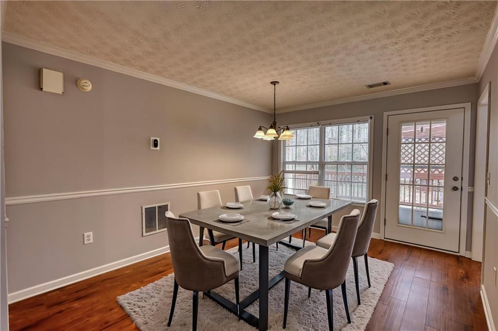 1006 English Oak Lane Winder, GA 30680 - Photo 10 of 83 a view of a dining room with furniture window and wooden floor