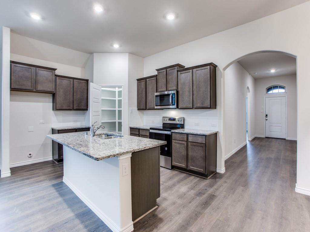 123 Lakeview Circle Pilot Point, TX 76258 - Photo 18 of 39 a kitchen with a sink cabinets and stainless steel appliances