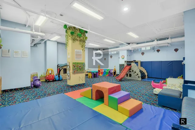 a view of a kitchen with a stove a washer and dryer