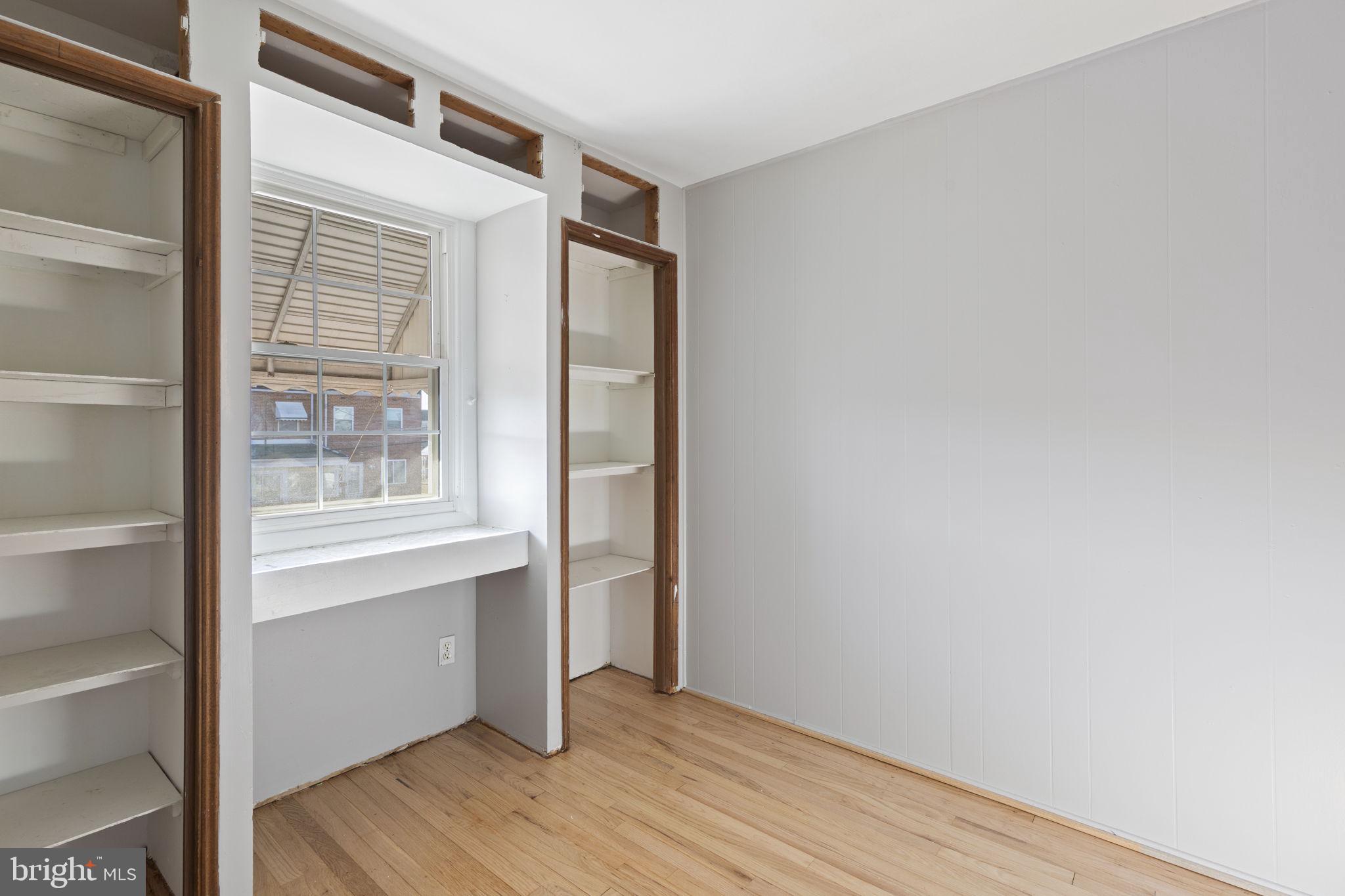 7731 Eastdale Road Baltimore, MD 21224 - Photo 13 of 26 a view of an empty room with wooden floor and a window