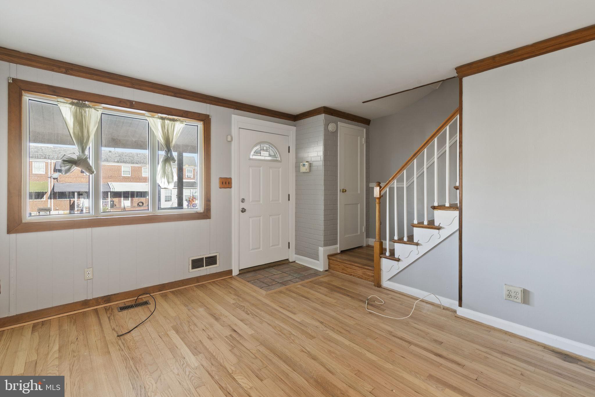 7731 Eastdale Road Baltimore, MD 21224 - Photo 5 of 26 a view of an empty room with wooden floor and a window