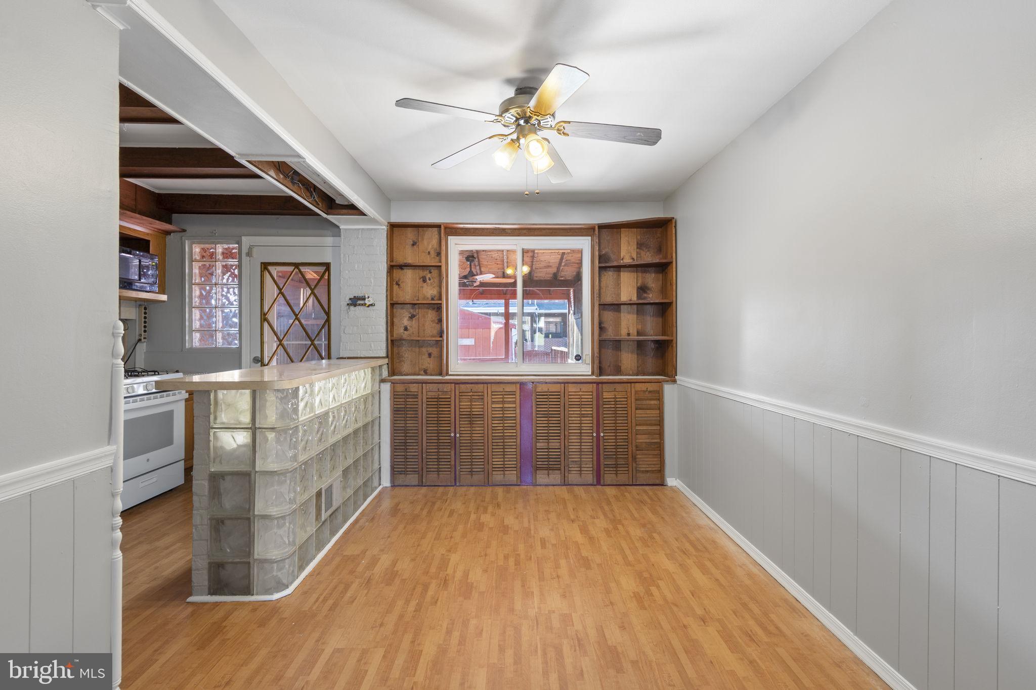 7731 Eastdale Road Baltimore, MD 21224 - Photo 7 of 26 wooden floor in an empty room with a window