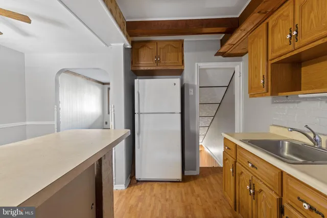 a kitchen with a refrigerator sink and cabinets