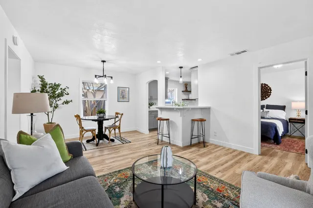 a living room with furniture and kitchen view