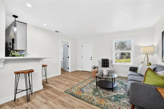 a living room with furniture and wooden floor