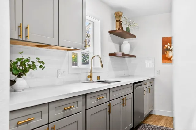 a kitchen with a sink and cabinets