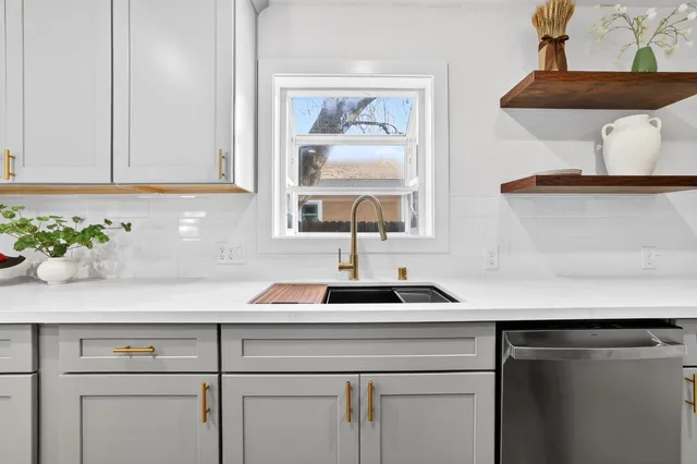 a kitchen with a sink a cabinets and window