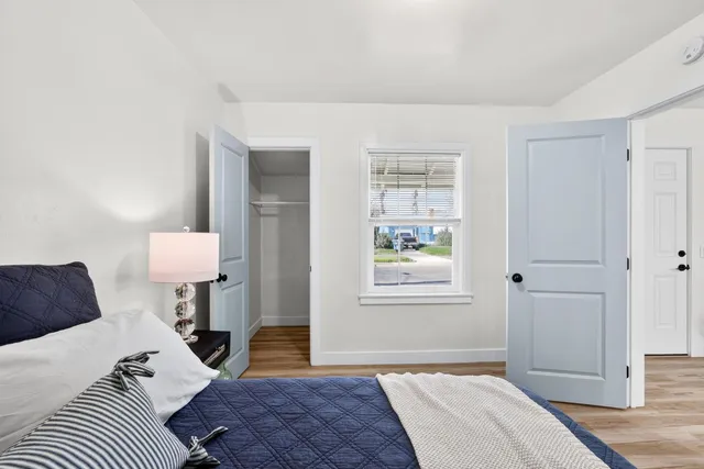 a bedroom with a bed and a lamp