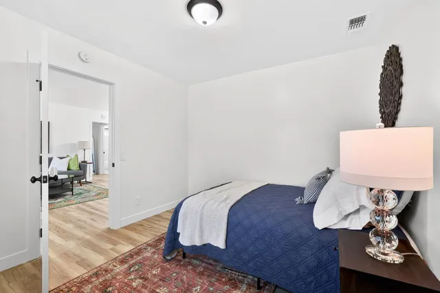 a bedroom with a bed and a chandelier