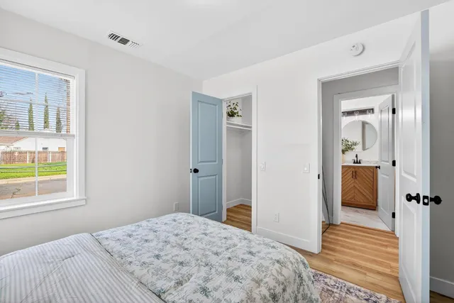 a bedroom with a bed and a window