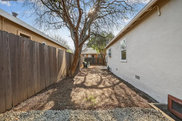 a backyard of a house with table and chairs