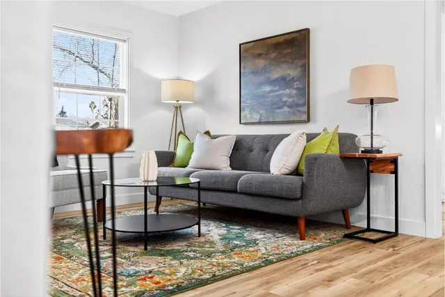 a living room with furniture and a lamp