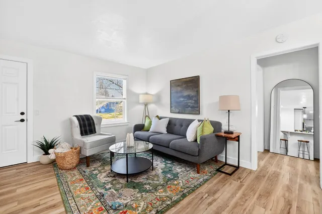 a living room with furniture or couch and a wooden floor