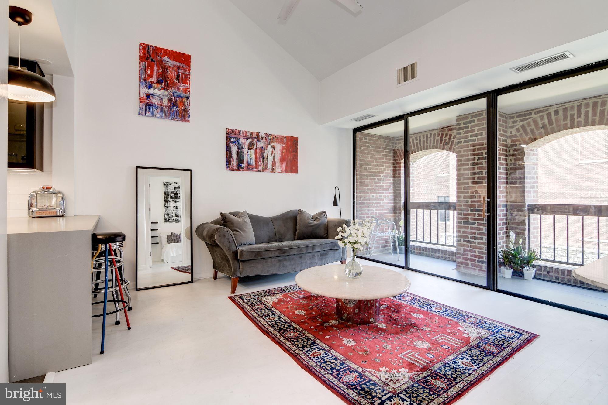 3225 Grace Street Northwest, Unit 208 Washington, DC 20007 - Photo 1 of 16 Living area w/access to balcony