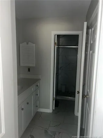 a bathroom with a shower and a sink