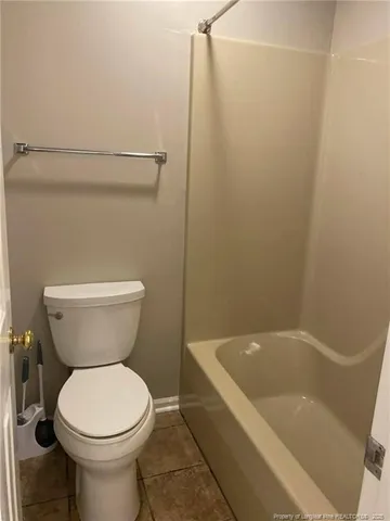 a bathroom with a toilet and bathtub