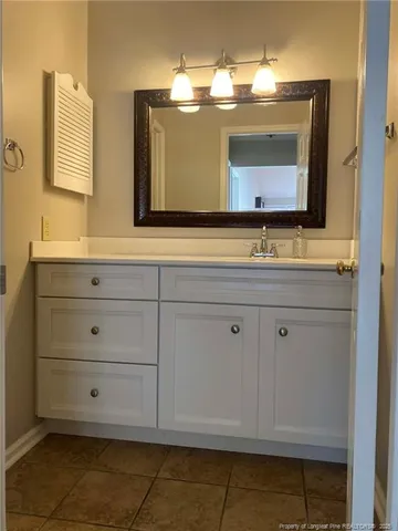 a bathroom with a sink vanity and mirror