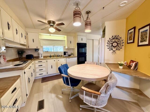 2605 South Tomahawk Road, Unit 46 Apache Junction, AZ 85119 - Photo 16 of 47 a kitchen with stainless steel appliances kitchen island granite countertop a sink a stove a dining table and chairs