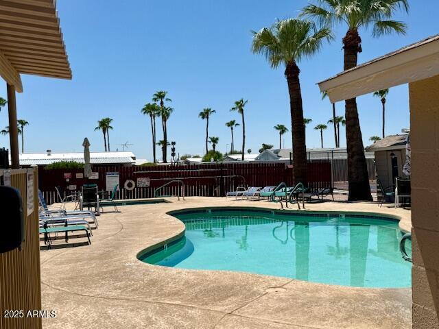 2605 South Tomahawk Road, Unit 46 Apache Junction, AZ 85119 - Photo 45 of 47 a view of a patio with table and chairs potted plants