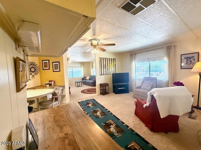 2605 South Tomahawk Road, Unit 46 Apache Junction, AZ 85119 - Photo 10 of 47 a living room with furniture and a flat screen tv