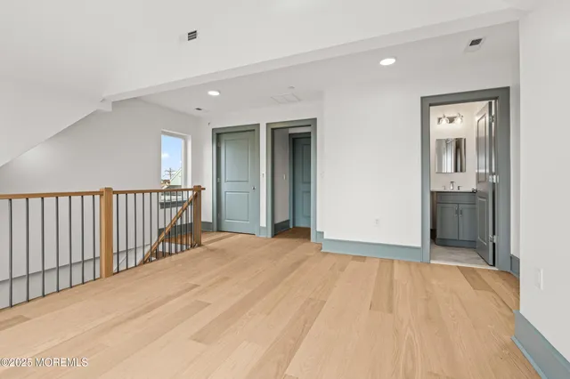 a bathroom with a toilet sink vanity and mirror