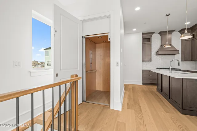 a view of a kitchen with a sink and a wooden floor