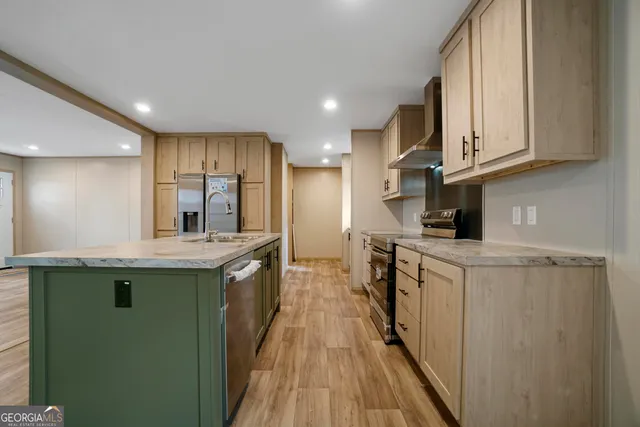 a kitchen with stainless steel appliances granite countertop a sink and cabinets