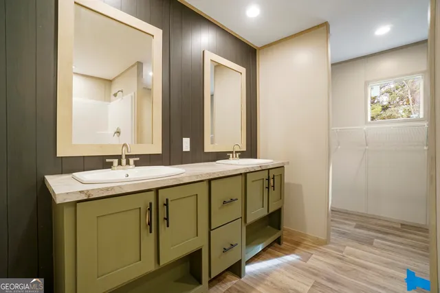 a bathroom with a double vanity sink and a mirror