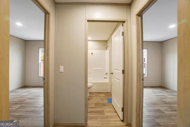 a view of a bathroom from a hallway