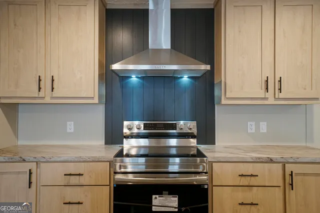 a stove top oven sitting inside of a kitchen