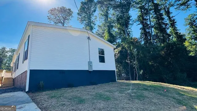 a backyard of a house with lots of green space and plants