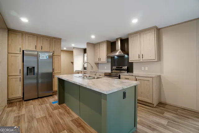 a kitchen with kitchen island sink refrigerator and cabinets