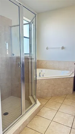 a bathroom with a bathtub and mirror