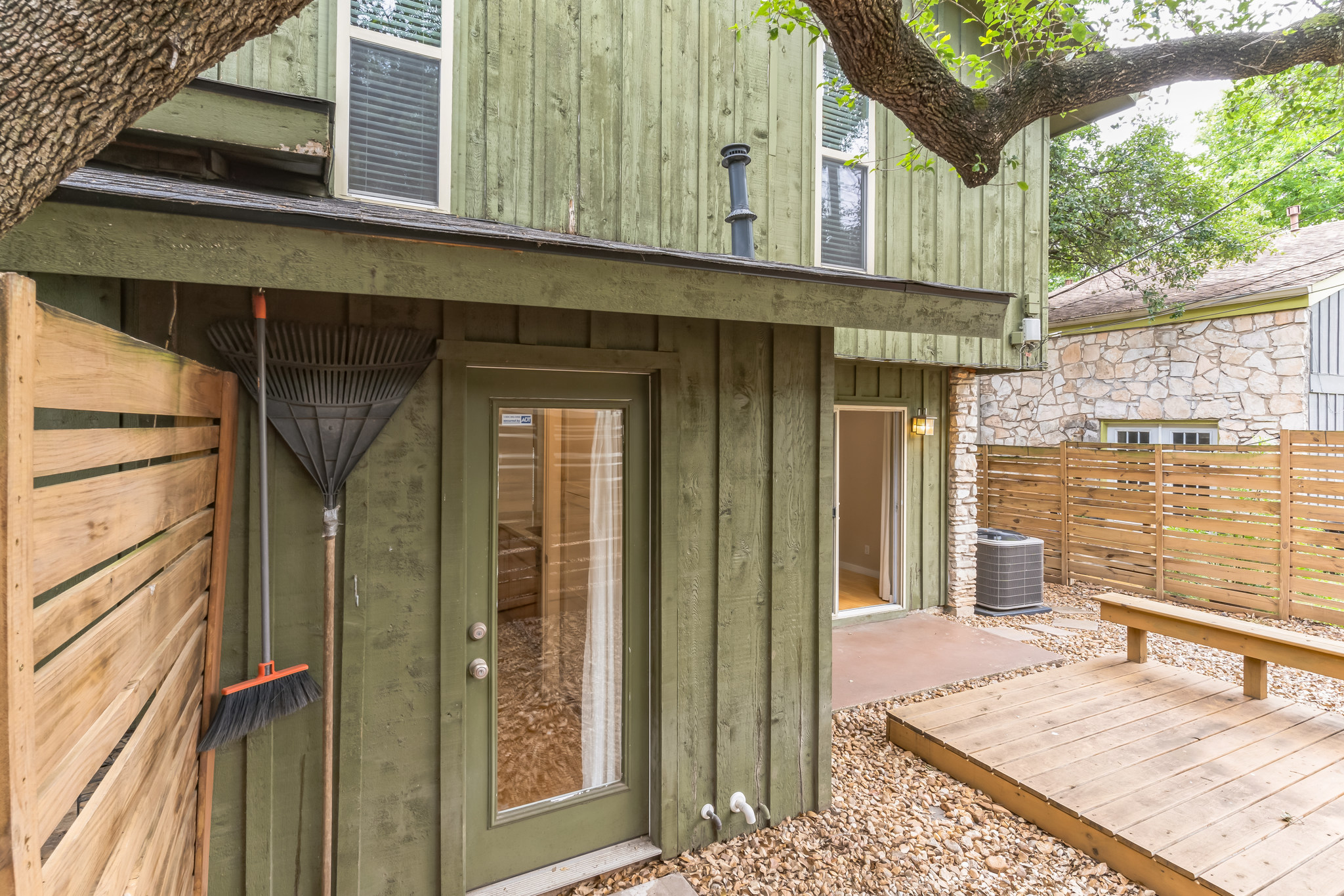 3214 Clawson Road, Unit A Austin, TX 78704 - Photo 23 of 26 A secluded outdoor living space features a wooden deck and privacy fencing, ideal for quiet enjoyment.