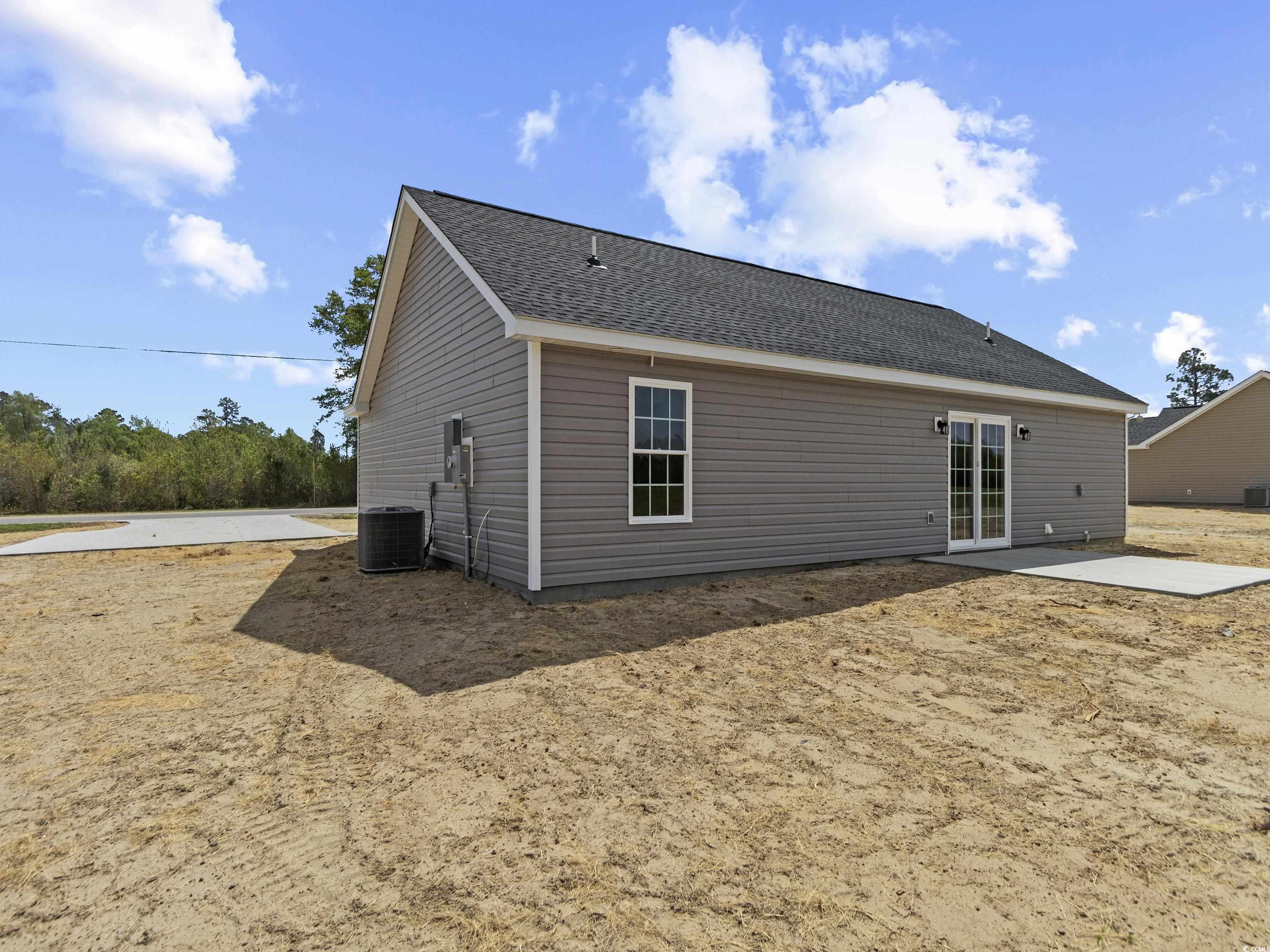 3427 B And S Road Loris, SC 29569 - Photo 7 of 33 Back of house featuring a patio and central air co