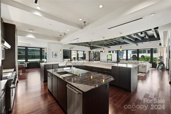 a kitchen with a table chairs stove and wooden floor
