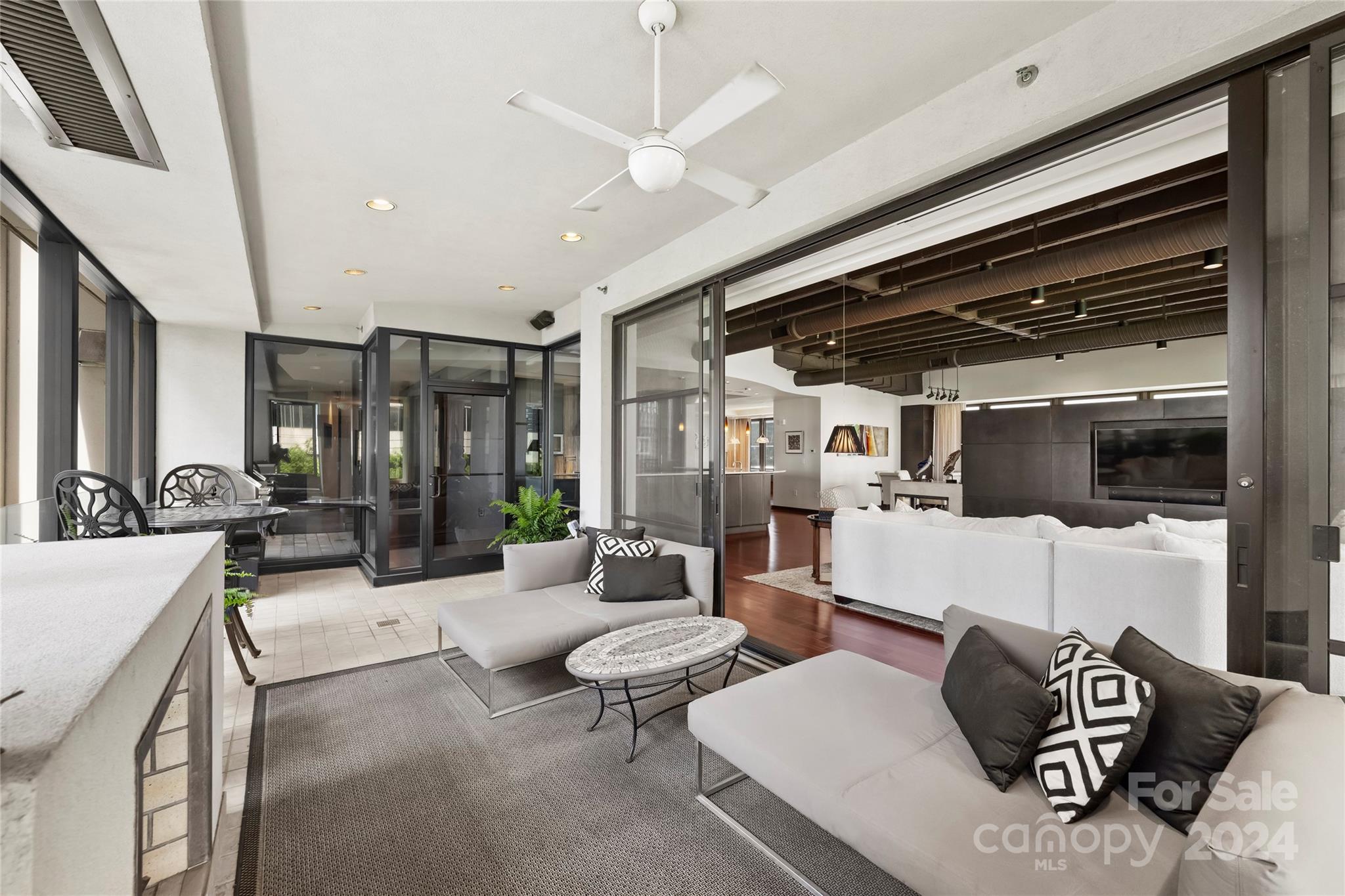 139 South Tryon Street, Unit 6 Charlotte, NC 28202 - Photo 11 of 48 a living room with furniture and a large window