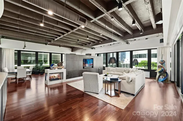 a view of a livingroom with furniture wooden floor and a chandelier