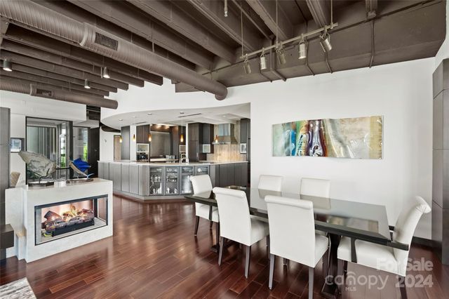 a view of a dining room with furniture wooden floor and a chandelier