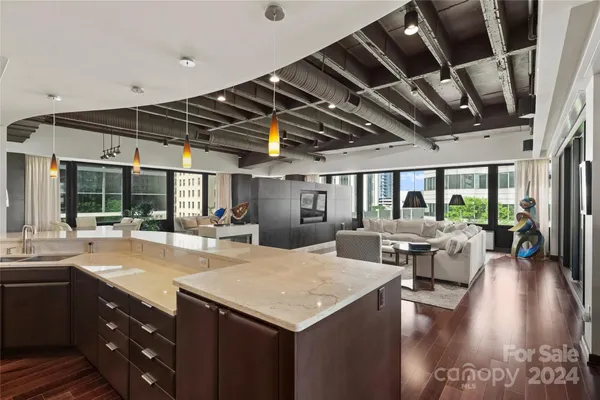 a kitchen with a table chairs and wooden floor