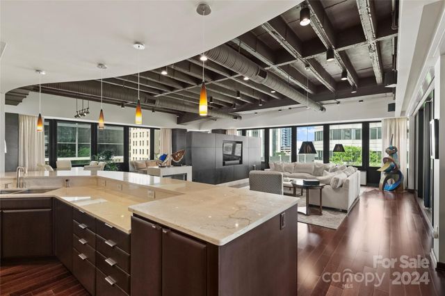 a kitchen with a table chairs and wooden floor