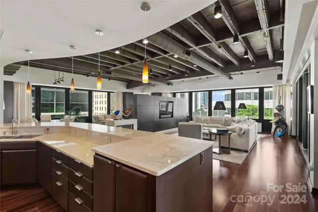 a kitchen with a table chairs and wooden floor