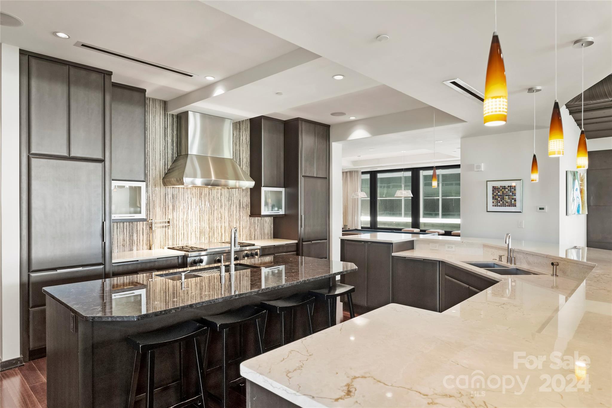 139 South Tryon Street, Unit 6 Charlotte, NC 28202 - Photo 19 of 48 a kitchen with counter top space cabinets and stainless steel appliances