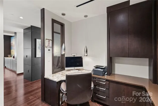 a view of workspace with wooden floor entryway