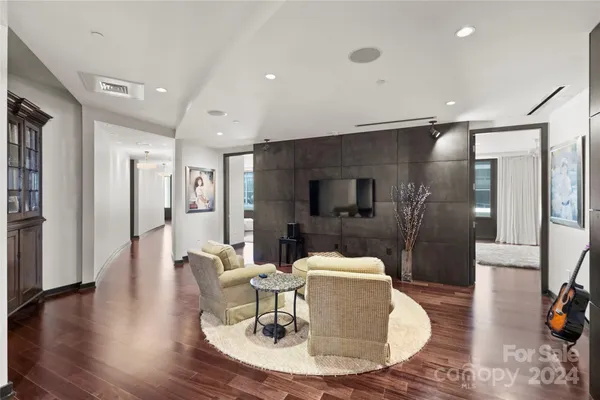 a dining room with furniture and wooden floor