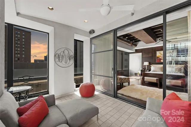 a living room with furniture a rug and a large window