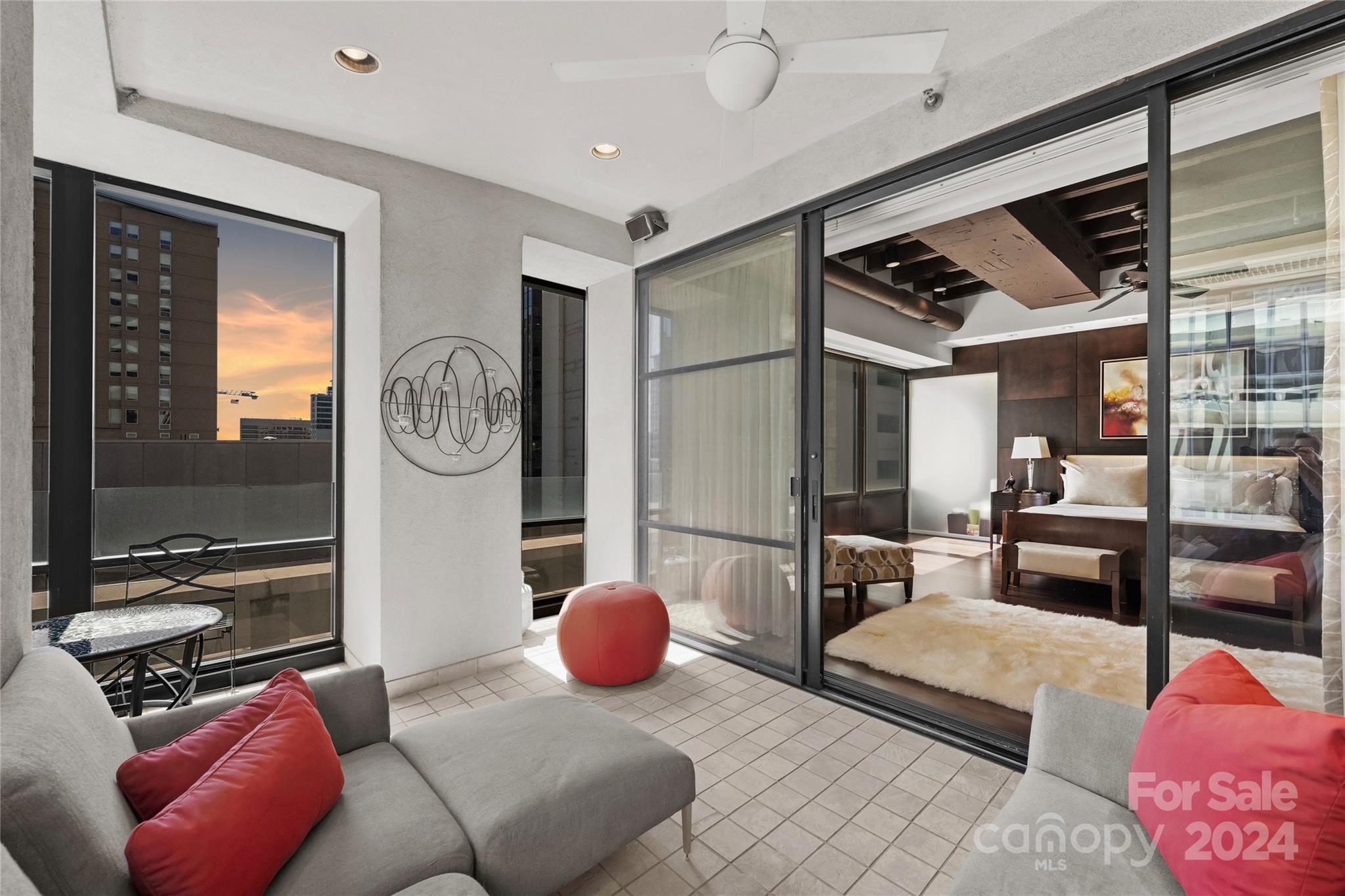 139 South Tryon Street, Unit 6 Charlotte, NC 28202 - Photo 28 of 48 a living room with furniture a rug and a large window